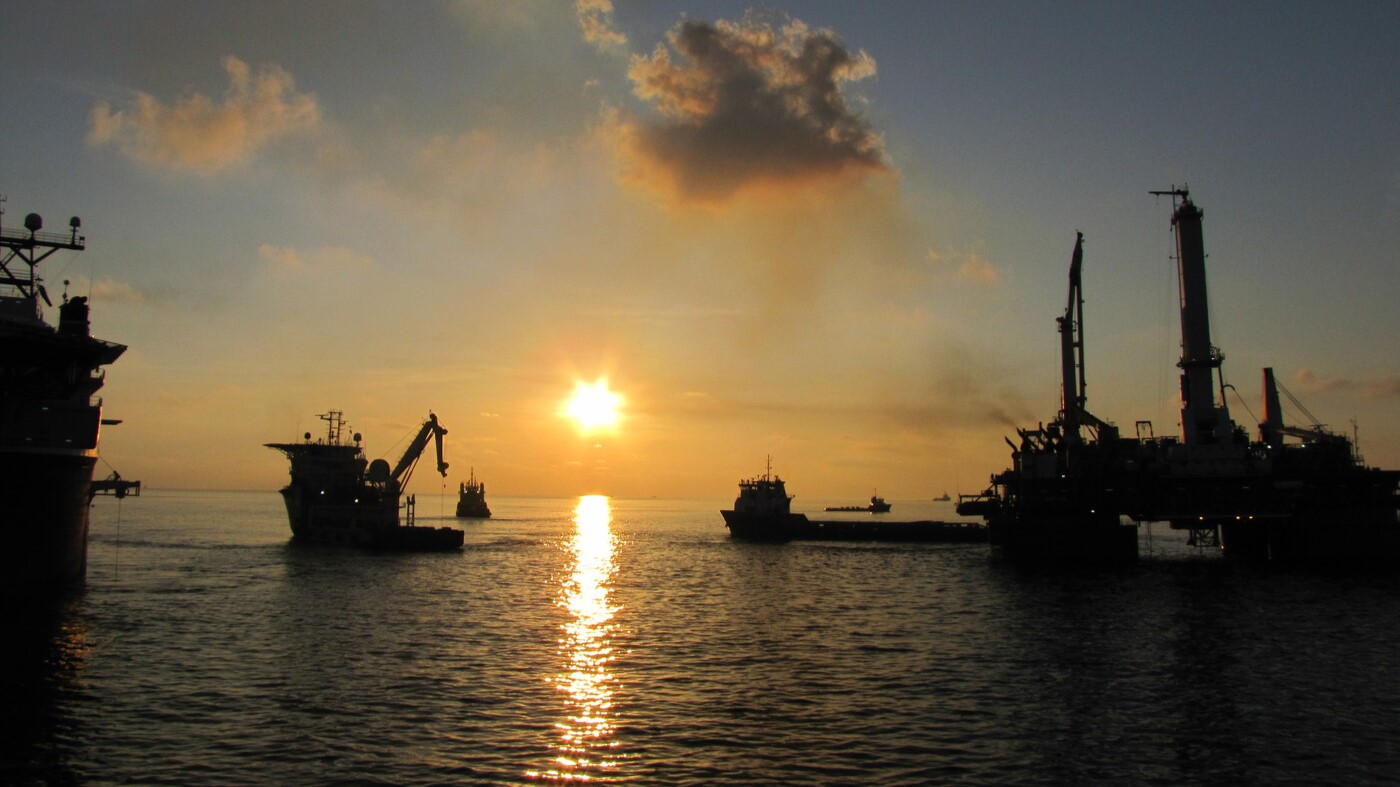 A serene offshore scene captures response vessels silhouetted against a fading sunset. Symbolising the industry’s journey from crisis to capability, the image serves as a visual metaphor for the resilience, innovation, and global cooperation that emerged in the wake of the Macondo incident. It complements the article’s closing reflection on readiness and shared responsibility.