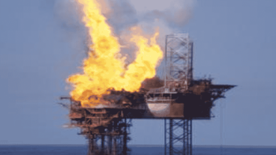 Large flames engulf the Montara oil platform, highlighting the intensity of the well blowout event.
