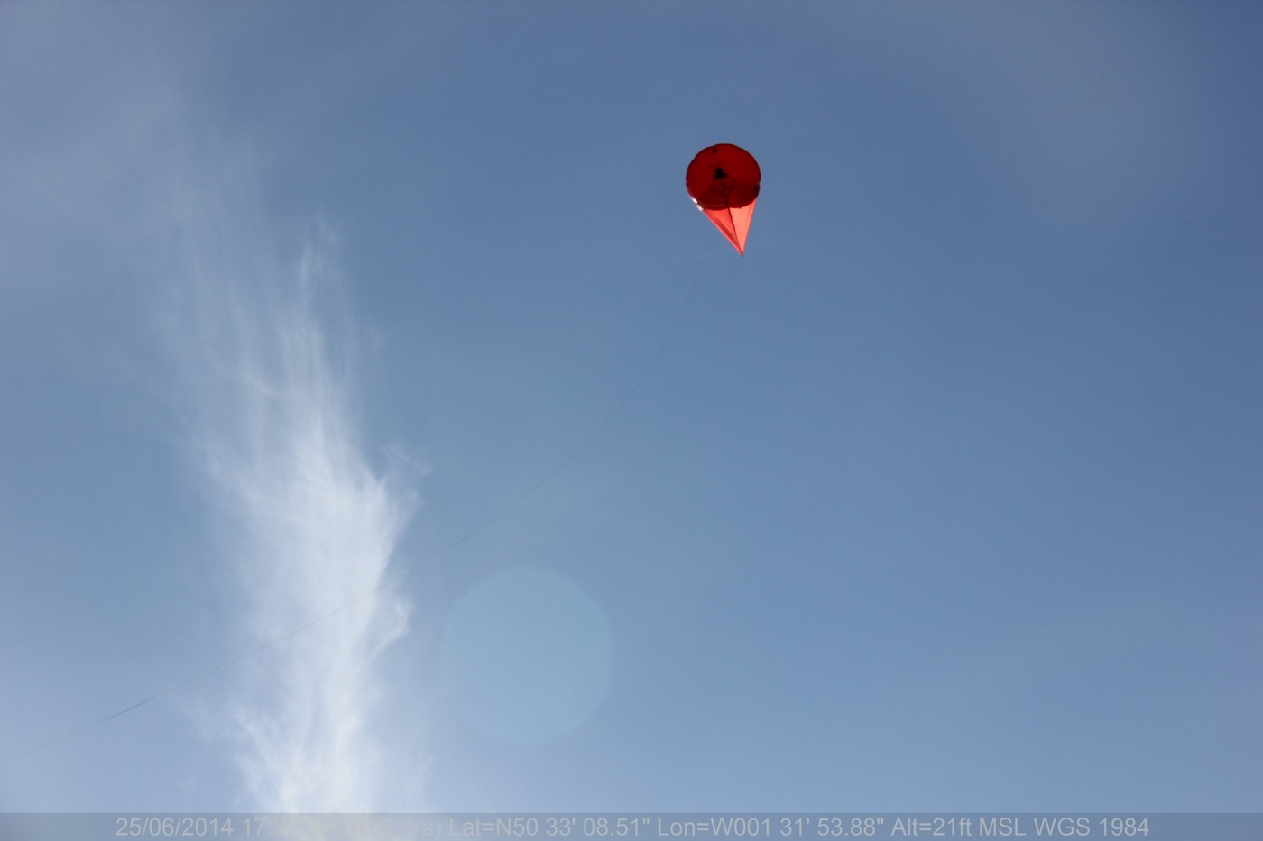 A high-altitude red aerial buoy deployed for monitoring and detecting oil spills in marine environments, providing real-time data.