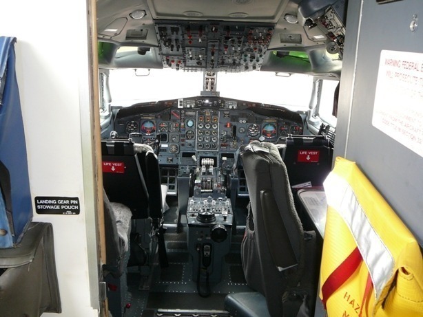 Rear angle view of the Boeing 727 aircraft parked inside a hangar, showcasing the triple-engine layout and OSRL branding.