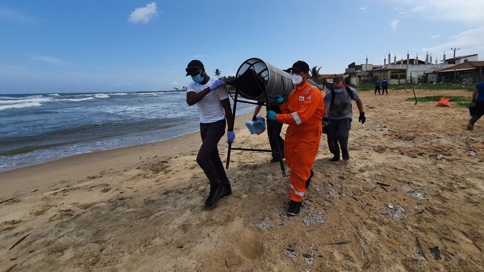 Responders relocating plastic pellet screening equipment along the shoreline
