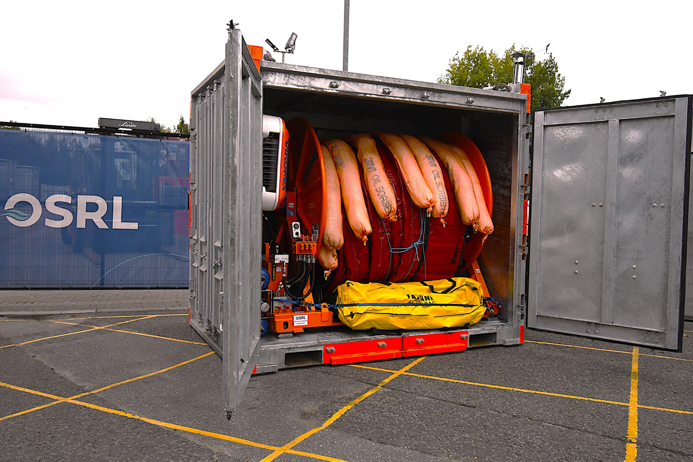 OSRL technicians preparing Ports and Harbours oil spill response equipment in containers
