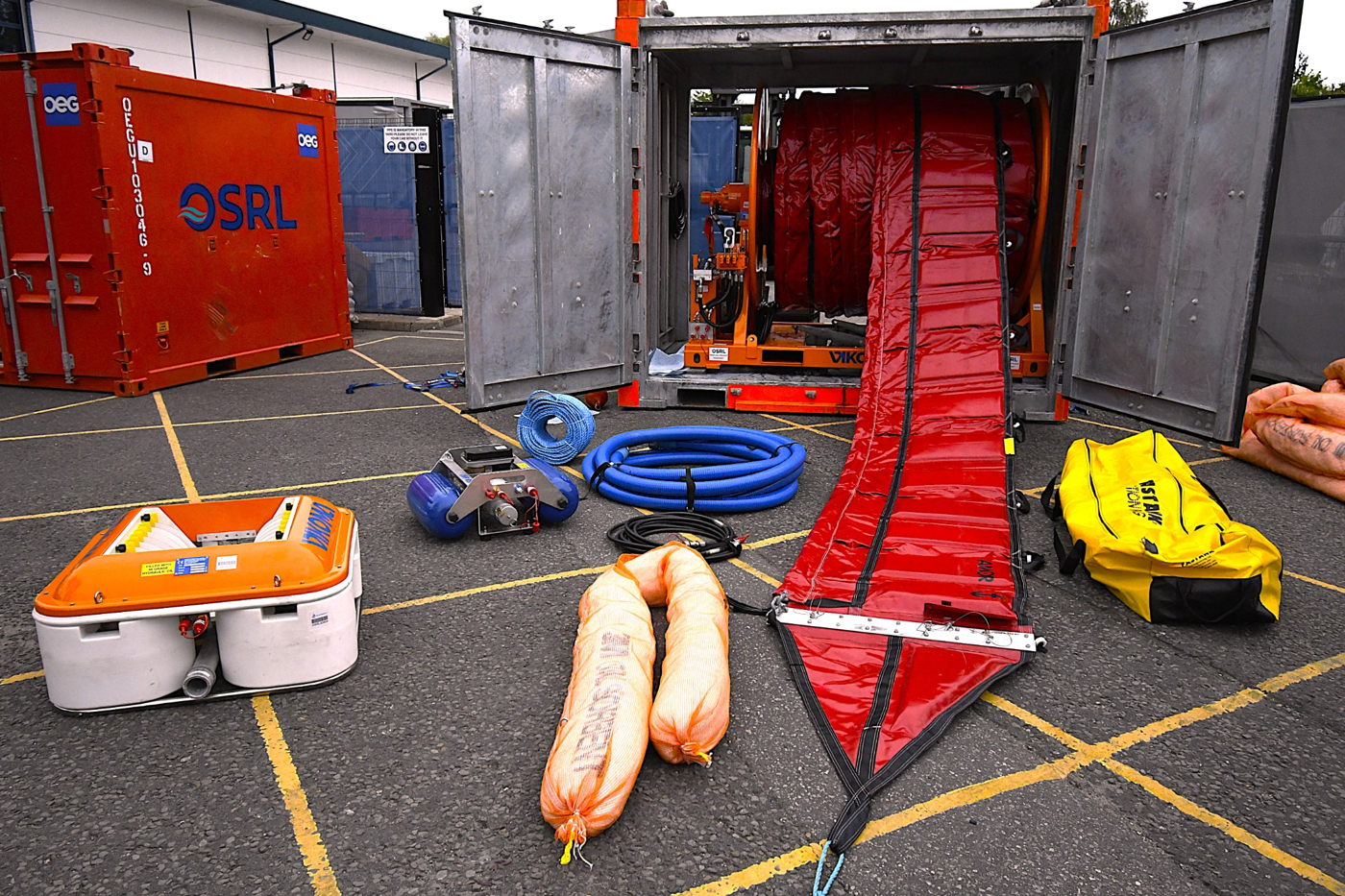 OSRL technician with Ports and Harbours oil spill response equipment