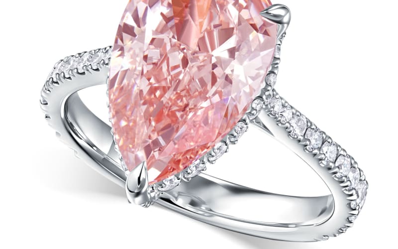 A pear-cut pink diamond ring photographed on white for e-commerce.