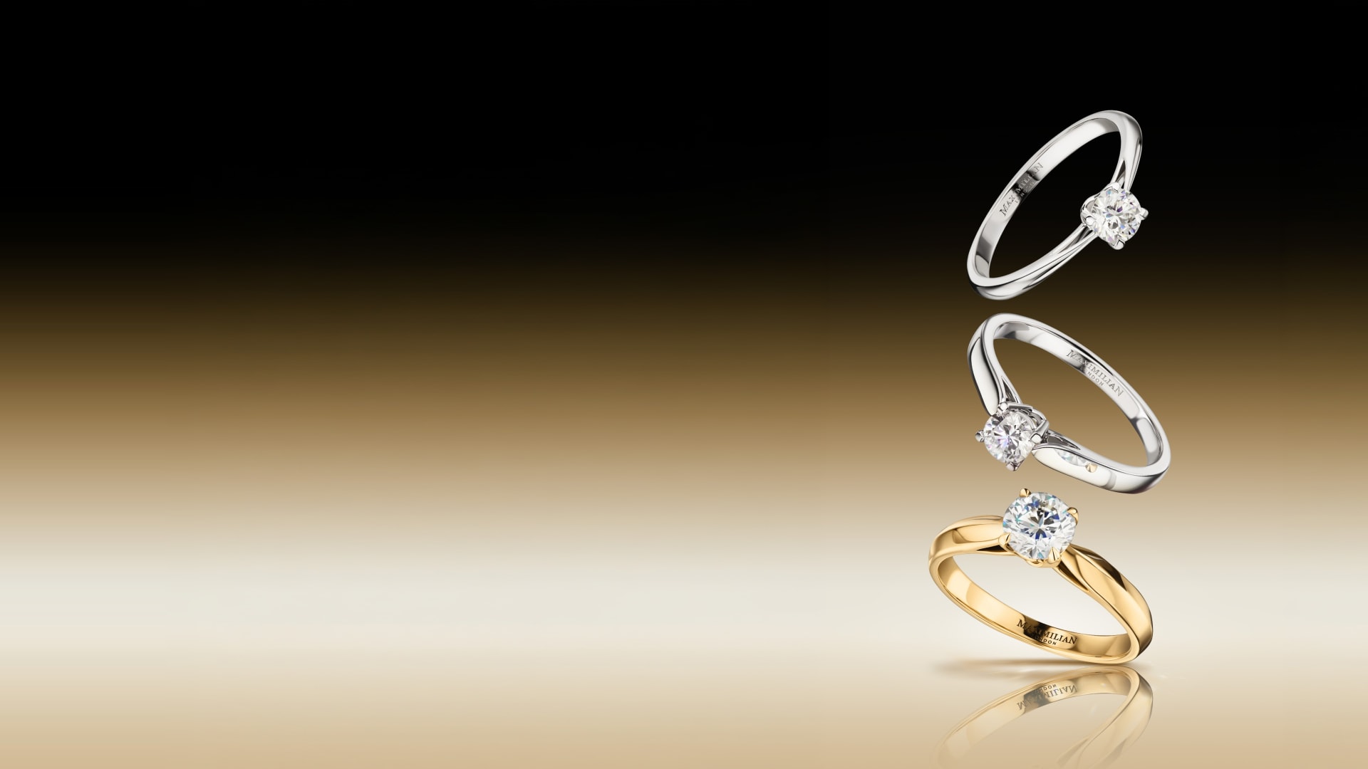 Three solitaire diamond rings suspended mid-fall against a black-to-gold gradient.