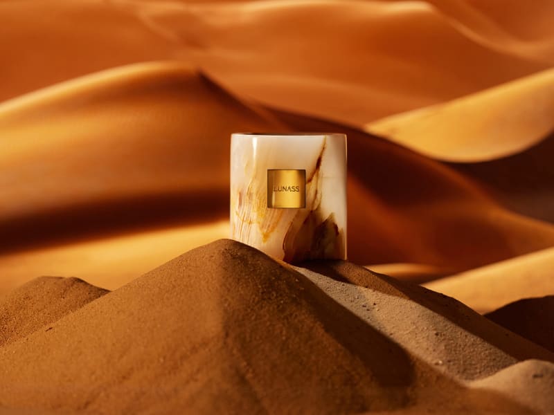 A cosmetic product surrounded by suspended texture.