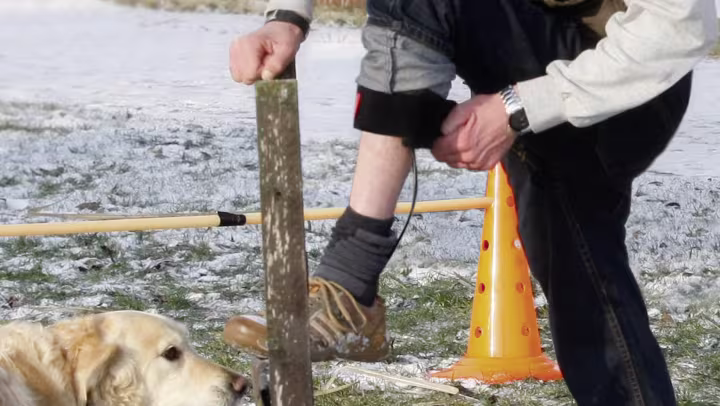 Người đàn ông đưa chân lên và đóng nẹp chỉnh hình