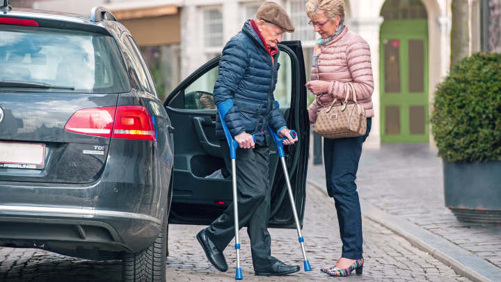 The user gets out of a car.