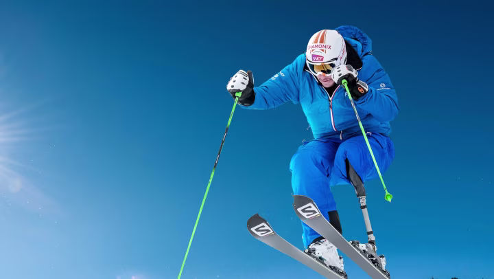 John enjoys the downhill tour on skis. 