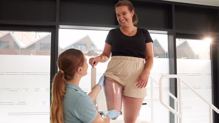 Female CPO and patient fitting Ottobock MyFit TF test socket in patient care center.