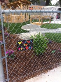 Fence with a sign that reads Welcome to Our Kids