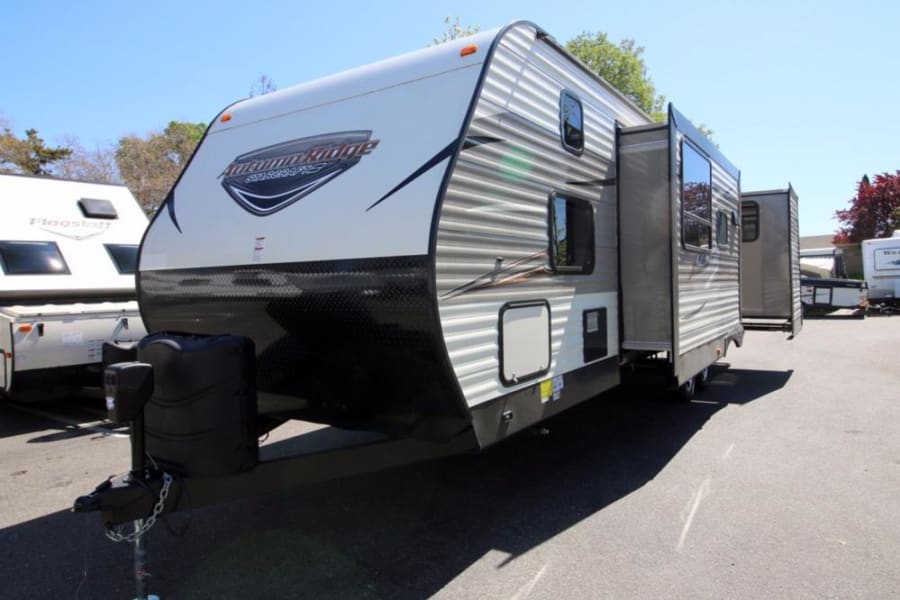 Explore this Starcraft Autumn Ridge travel trailer with an extended slide-out, perfect for your next RV rental adventure.