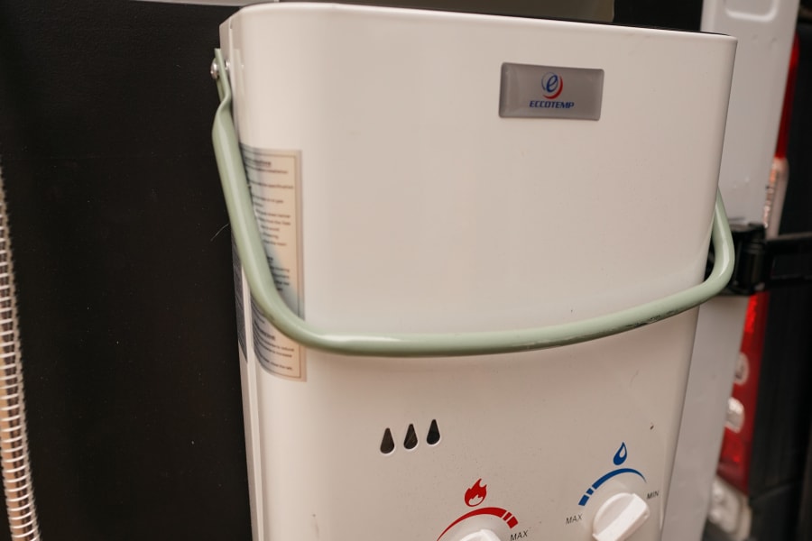 An Eccotemp portable water heater provides an outdoor shower in this RV rental, offering convenience for campers.