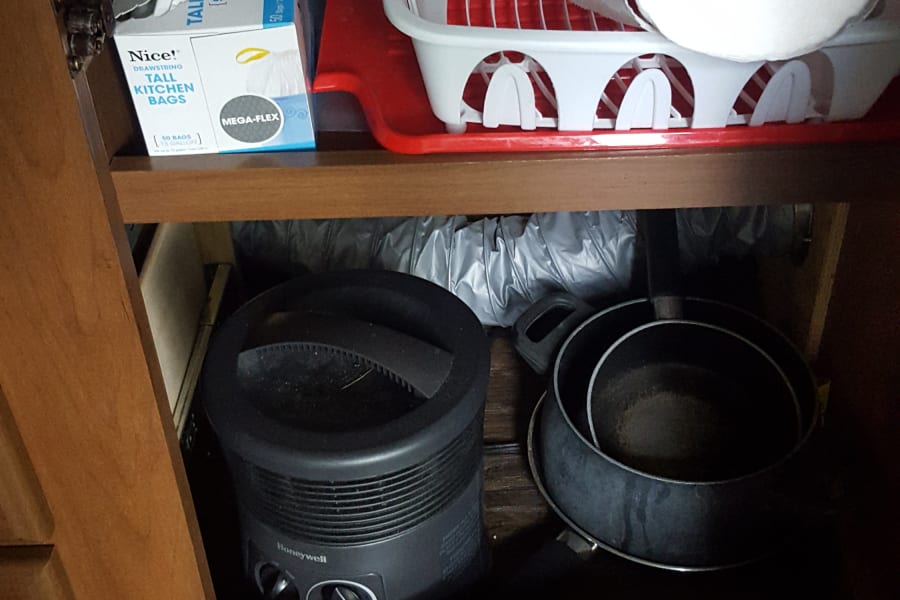 Dish strainer, garbage sacks, small electric heater. Frying pan, medium pot and small pot.