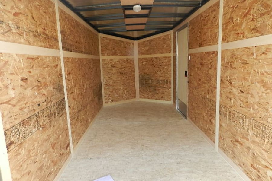 Spacious, empty enclosed trailer interior with OSB walls & floor, ready for rv rental or storage.