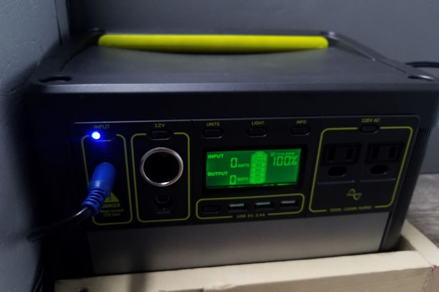 A Goal Zero Yeti portable power station, fully charged at 100%, is seen, ideal for powering electronics in an RV rental.