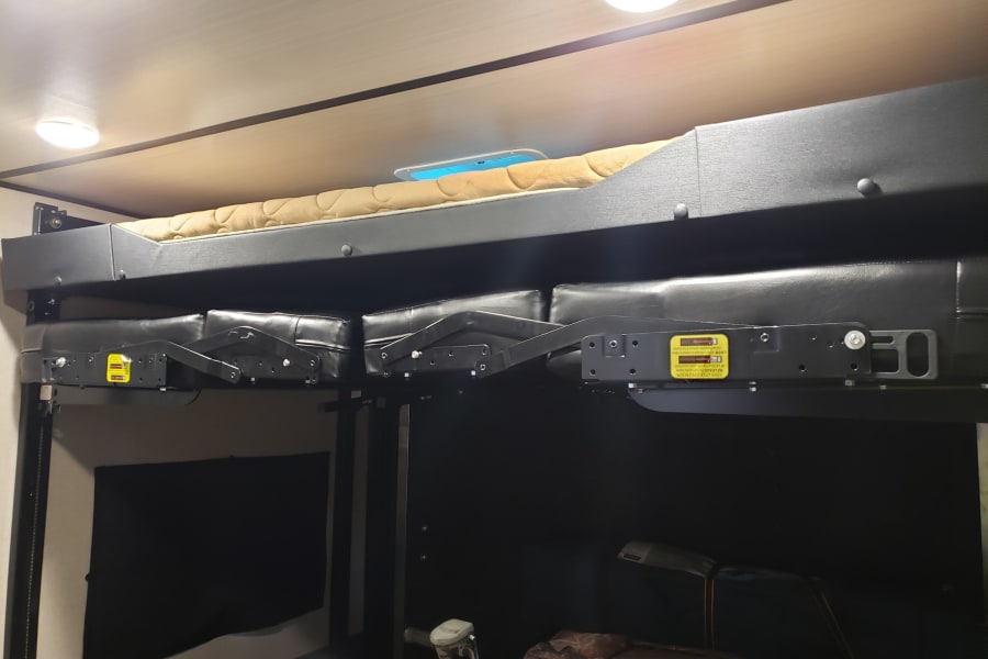 Electric double bunks in back, lower bunk folds into 2 couches