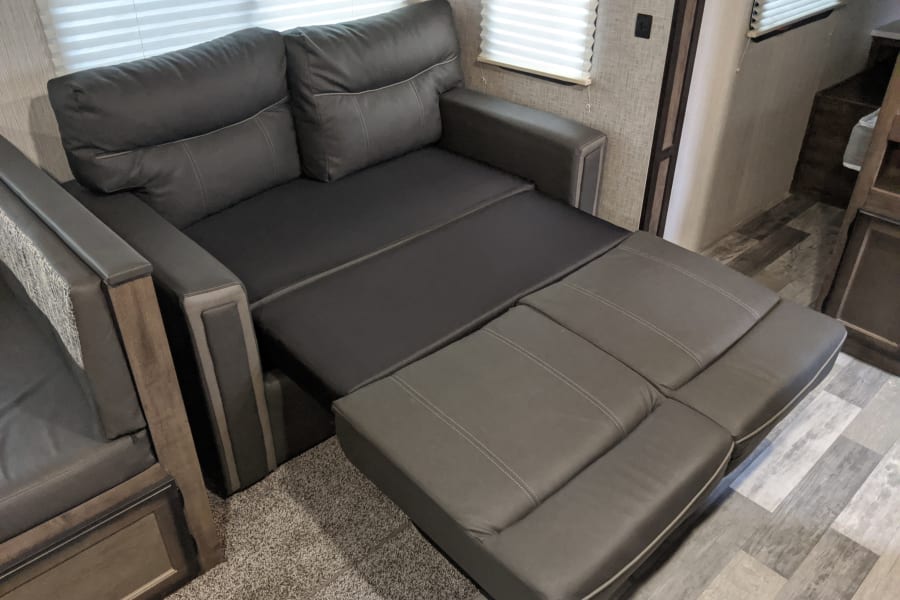 Couch folded out into a bed. Around the size of a Full bed.