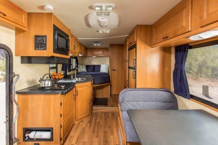 Well-equipped rv rental with kitchen, dinette, and rear bed for comfortable road trips.