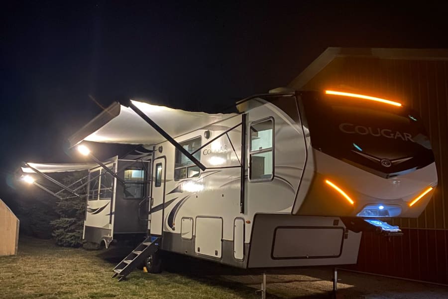 What the camper looks like all lit up at night and awnings out.
