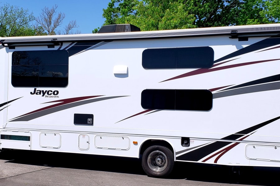 A large Jayco Redhawk RV rental parked outdoors, ready for road trips & adventure.
