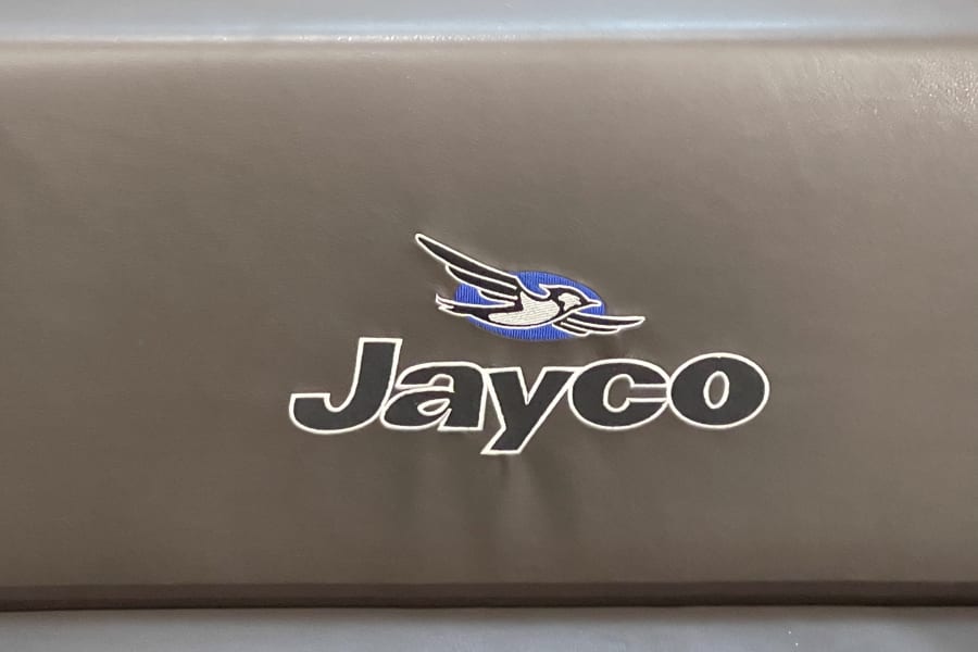 Jayco RV logo: a stylized bird above "Jayco" text, visible on RV rental vehicles.