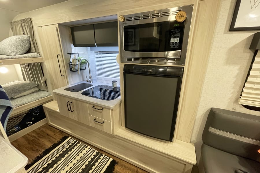 The refrigerator works on both gas and electric. The microwave is also a convectional oven for your baking needs.