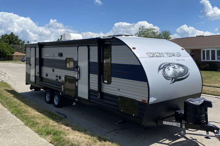 RV rental: Grey Wolf travel trailer parked on a sunny day. Perfect for your next outdoor adventure.