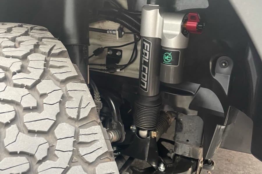 Rugged Falcon off-road suspension and aggressive tire on a vehicle, providing durability for any RV rental adventure.