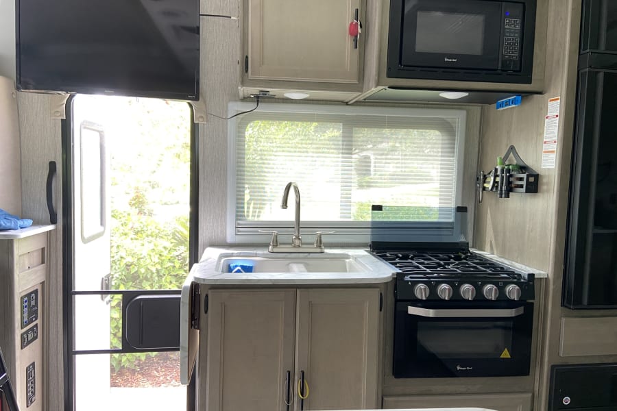 The kitchen comes with a gas stove three top burner microwave double sink and the countertop that extends for more room.   