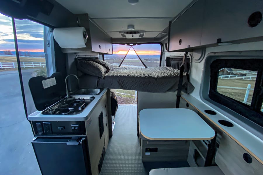 Full bed in sleeping position. Interior living area.  Dinette converts to second sleeping area.  Full bug netting to all doors and entries. 