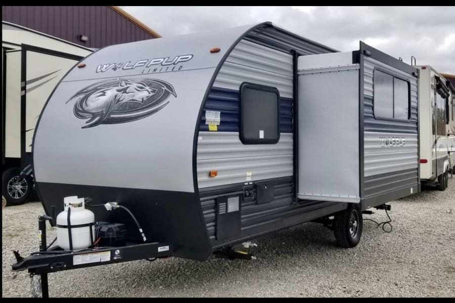 Explore this compact Wolf Pup travel trailer, ideal for your next rv rental adventure with an extended slide-out.