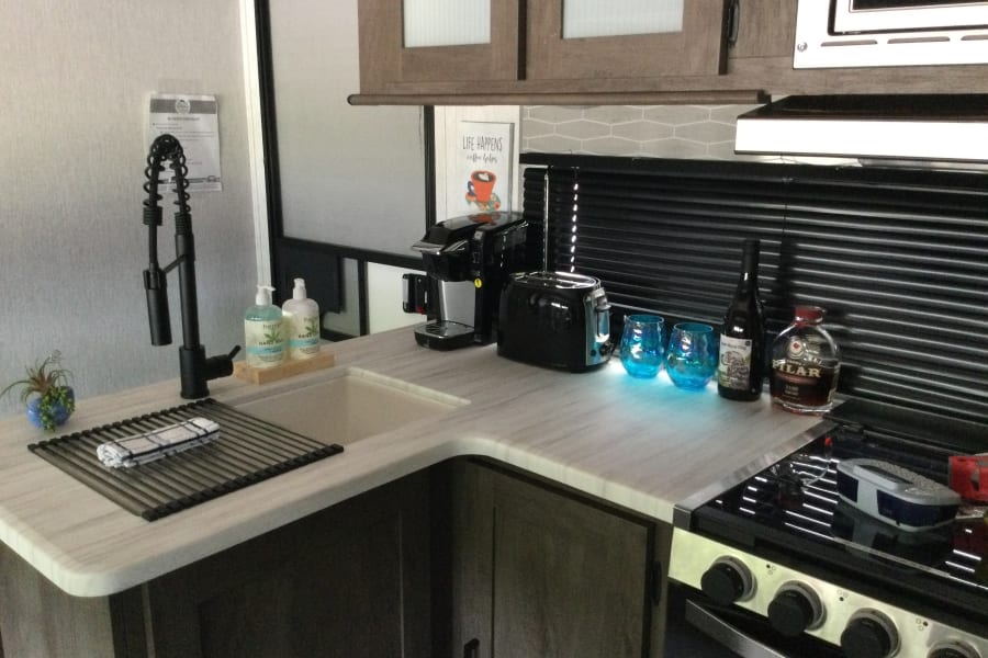 The kitchen provides you with state-of-the-art appliances, with a 3-burner stove, oven and microwave.  12V frigerated, and 2 sided sink.  Coffee incl.