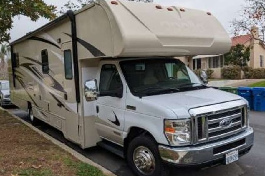This tan and white Class C motorhome is an ideal RV rental, ready for your next adventure.