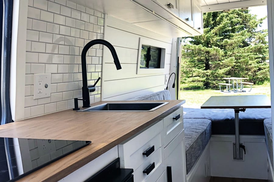 Kitchen Area:  Refrigerator, Induction Stove, Deep Sink, Under Sink Storage.  Plenty of space to cook and eat!