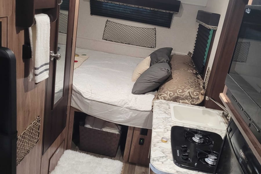 Queen bed, kitchen and bathroom entry door. 