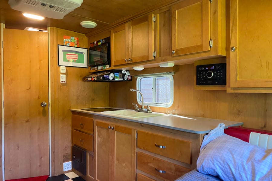 Everything you need to cook and clean up.  Two burner cook top (with microwave above the fan), Double sided sink for clean up.