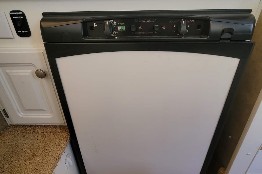 RV rental Dometic refrigerator, showing detailed controls & fan switch for optimal cooling.