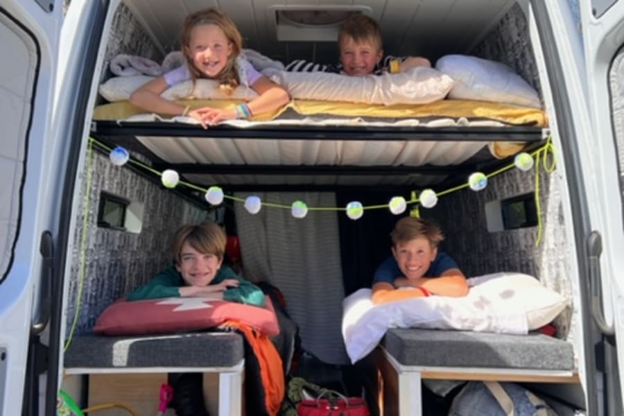 The kids are showing off the cozy beds!  Two beds below on the bench seats and 1 double platform bed up above.  Easy to set up and take down.