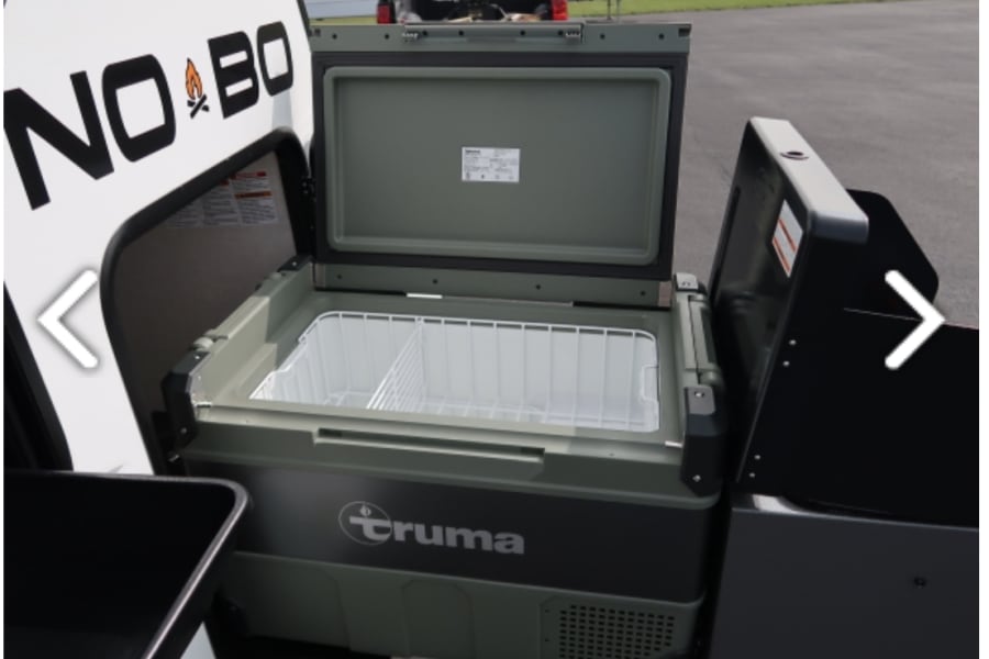 Explore RV rental comforts: A Truma portable fridge/freezer with an open lid, perfect for outdoor kitchen adventures.