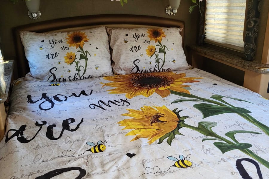 RV queen bed with a window on each side.