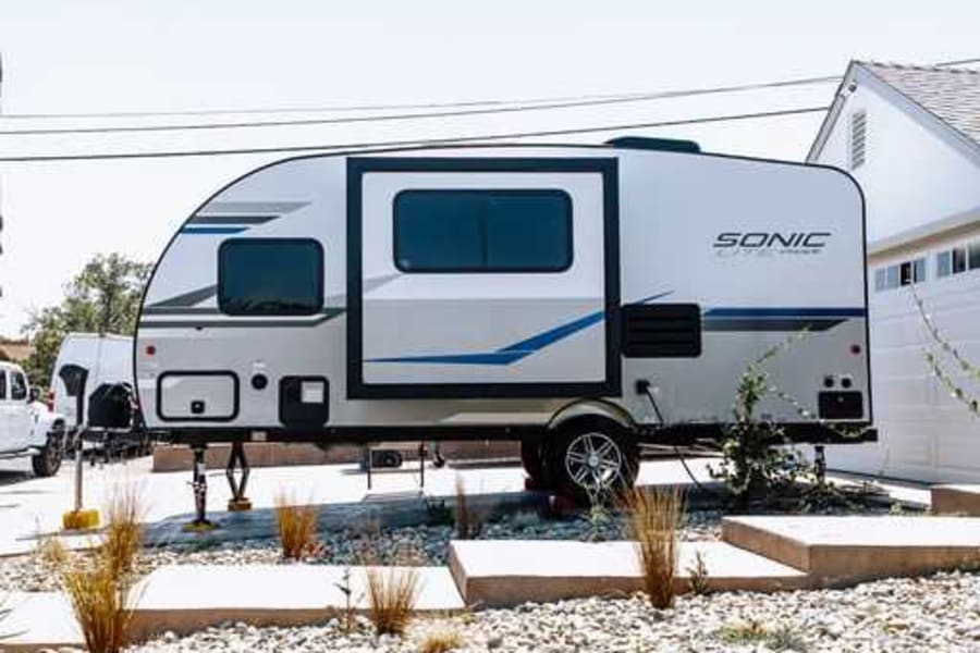 Sonic travel trailer RV rental parked at home, ready for your next outdoor adventure.