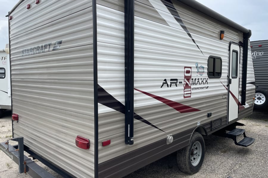 Explore the outdoors with this StarCraft travel trailer RV rental. This recreational vehicle features an awning and entry steps.
