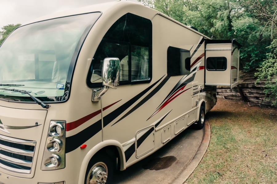 Spacious beige RV rental with extended slide-out, ready for your next adventure. Perfect for road trips.
