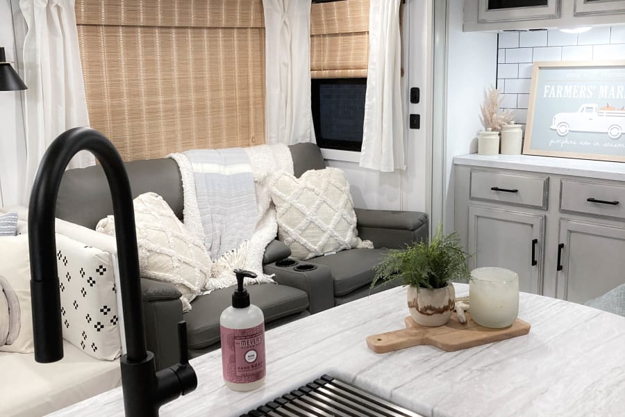 Stylish RV rental featuring a well-appointed kitchen, comfortable seating area, and cozy decor.