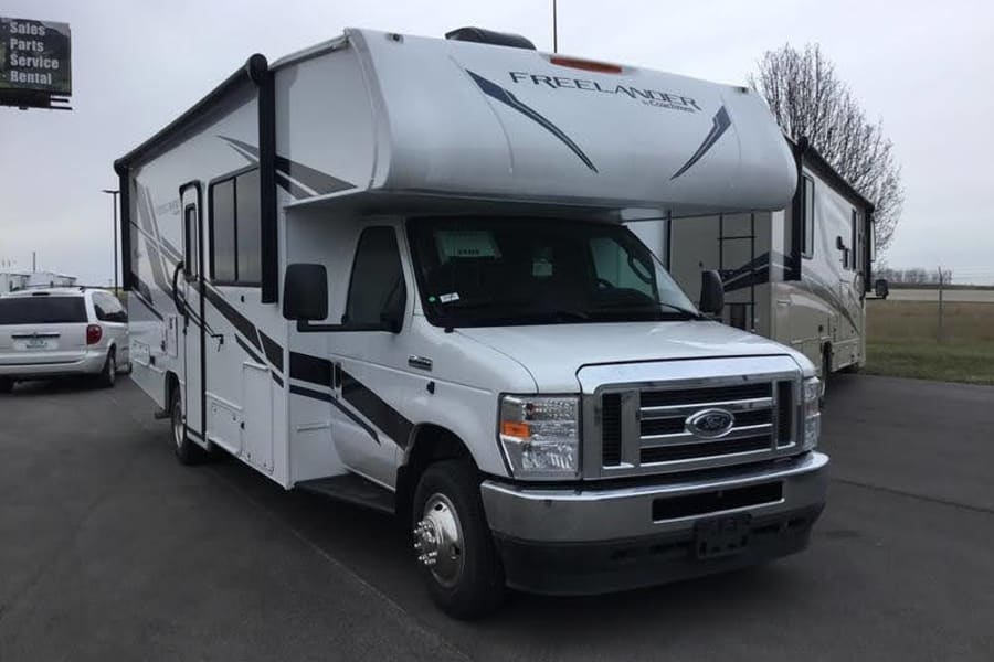 The RV fits in one parking space wide, two deep. But you will want two wide for entering and exiting the coach comfortably and putting the slides out.