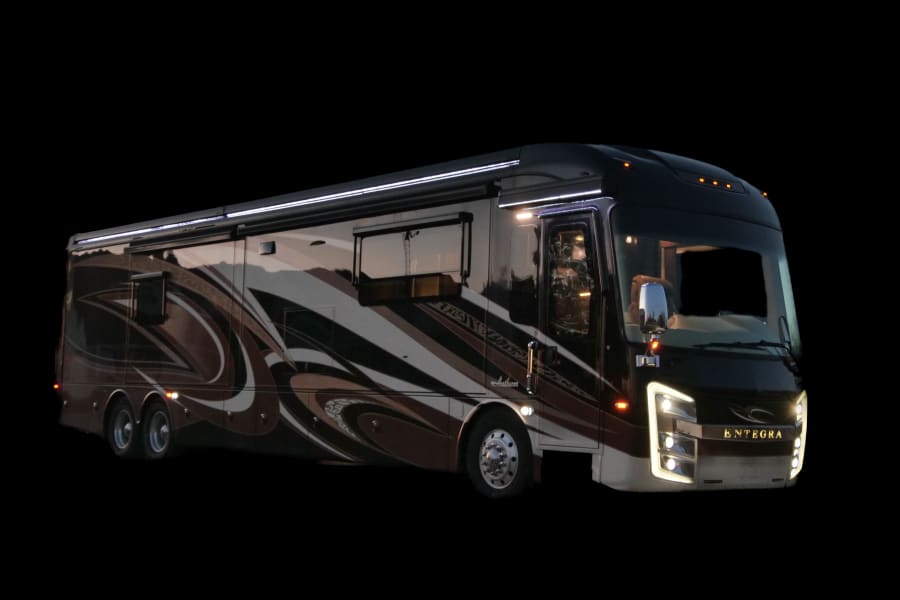 A modern, illuminated Entegra Anthem luxury motorhome, perfect for your next rv rental adventure.