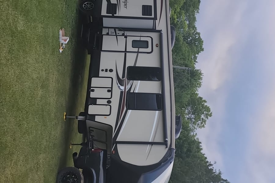 Explore the outdoors with this large Sandpiper RV rental, perfectly paired with a powerful pickup truck for your next adventure.