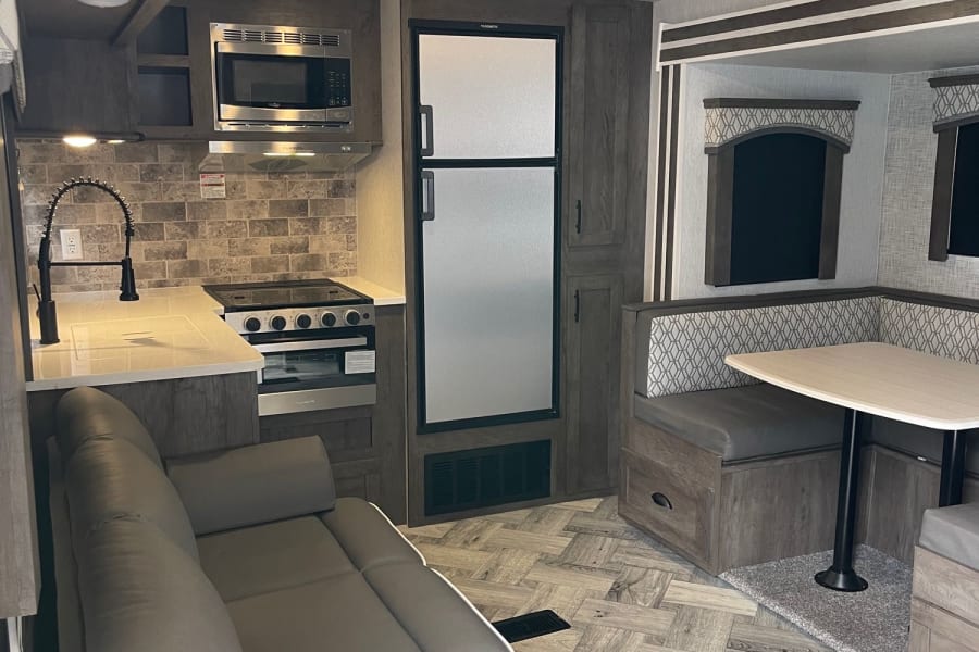 Plenty of counter space, large fridge, dining turns into extra bed, wall mounted tv in living. 