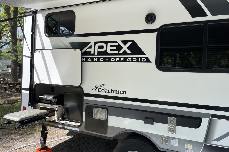 Exterior lp burner, electrical outlet, speakers and mini fridge